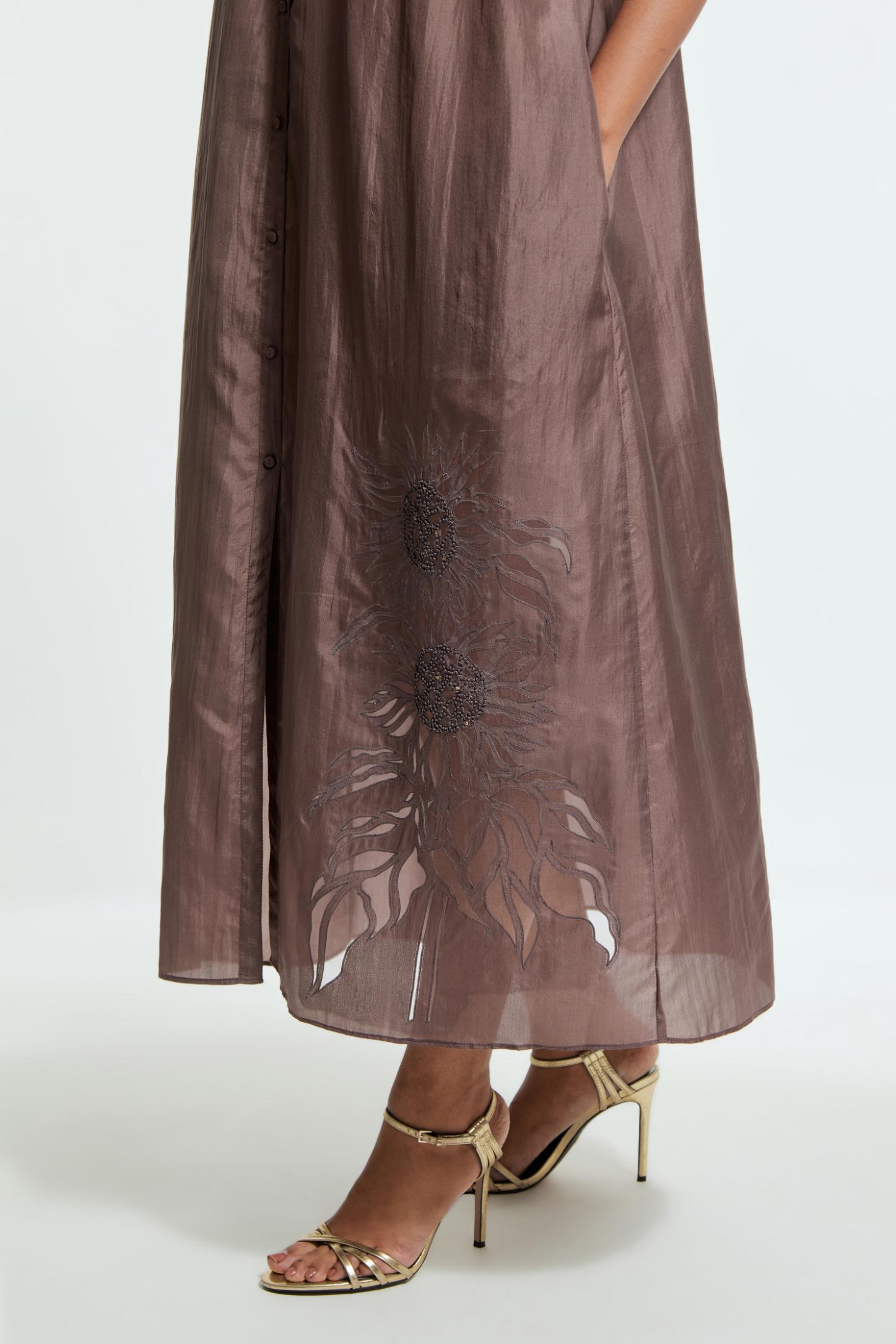 Grey silk long dress adorned with appliqué chrysanthemum floral motifs along one side, delicately highlighted with fine French knots and subtle sequins.