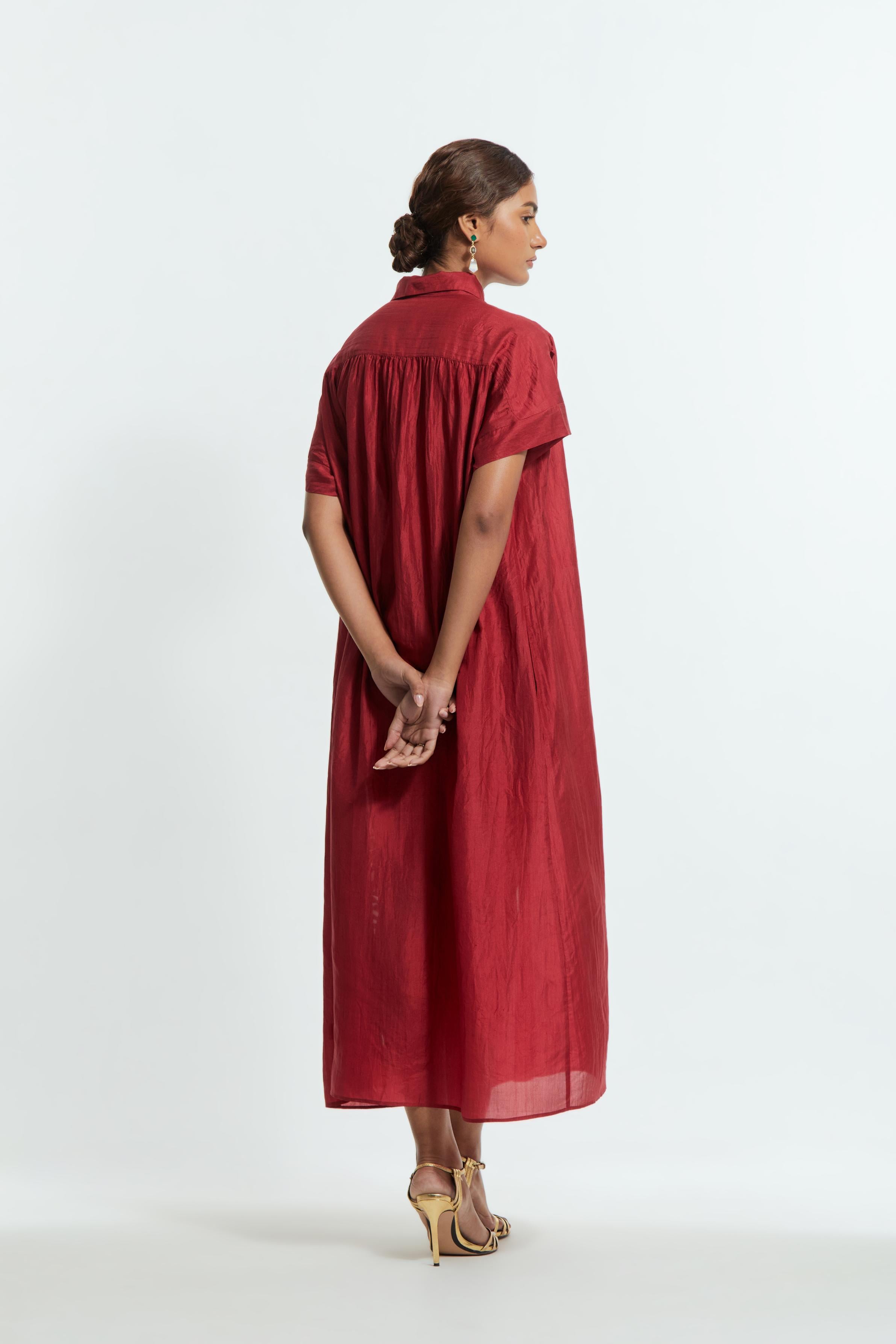 Red silk long dress adorned with appliqué chrysanthemum floral motifs along one side, delicately highlighted with fine French knots and subtle sequins.