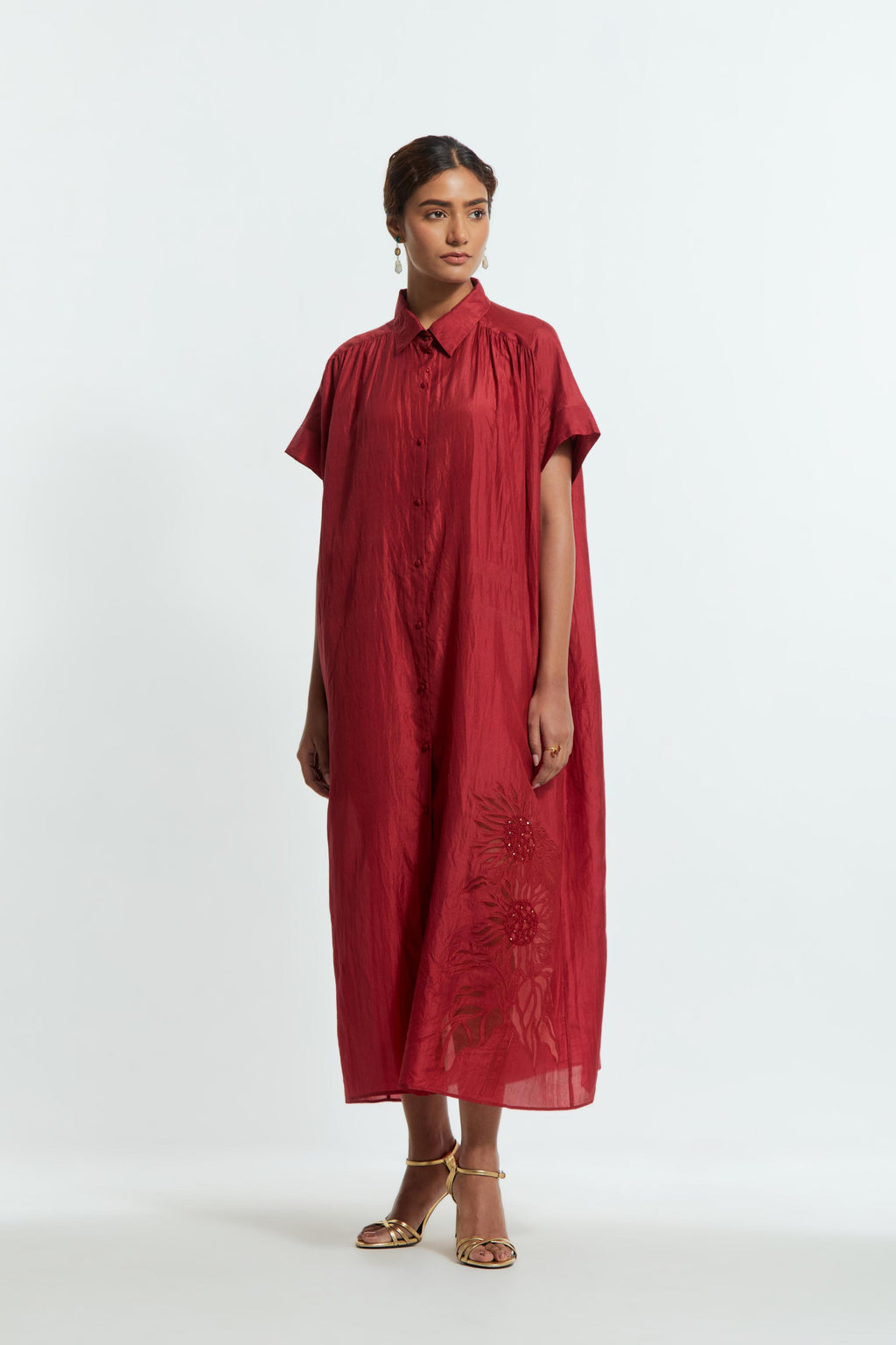 Red silk long dress adorned with appliqué chrysanthemum floral motifs along one side, delicately highlighted with fine French knots and subtle sequins.