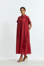 Red silk long dress adorned with appliqué chrysanthemum floral motifs along one side, delicately highlighted with fine French knots and subtle sequins.