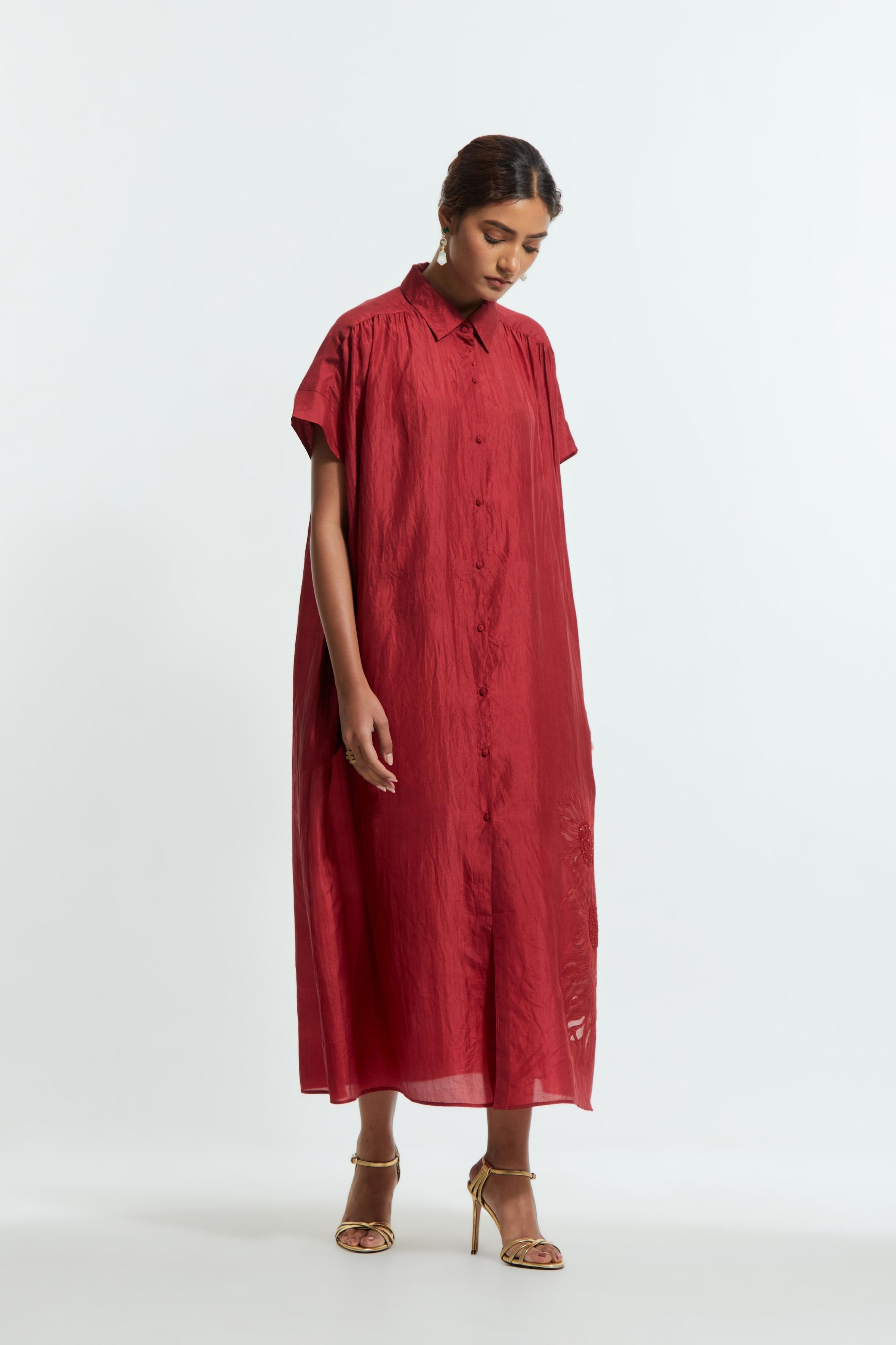 Red silk long dress adorned with appliqué chrysanthemum floral motifs along one side, delicately highlighted with fine French knots and subtle sequins.