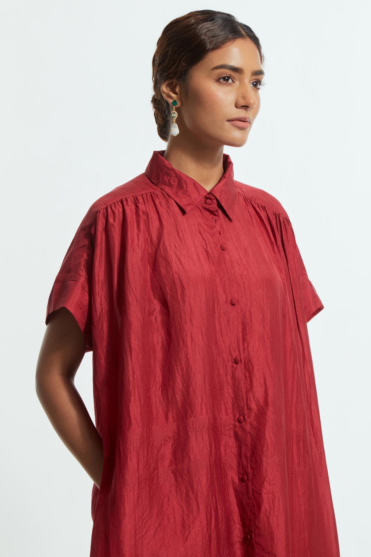 Red silk long dress adorned with appliqué chrysanthemum floral motifs along one side, delicately highlighted with fine French knots and subtle sequins.