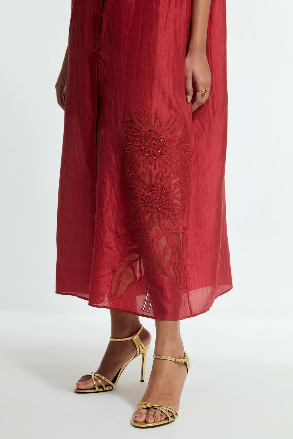 Red silk long dress adorned with appliqué chrysanthemum floral motifs along one side, delicately highlighted with fine French knots and subtle sequins.