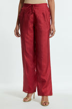 Red silk straight pants detailed with scalloped organza edging at the hem, delicately highlighted with gold sequins work.