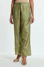 Green silk straight pants detailed with scalloped organza edging at the hem, delicately highlighted with gold sequins work.