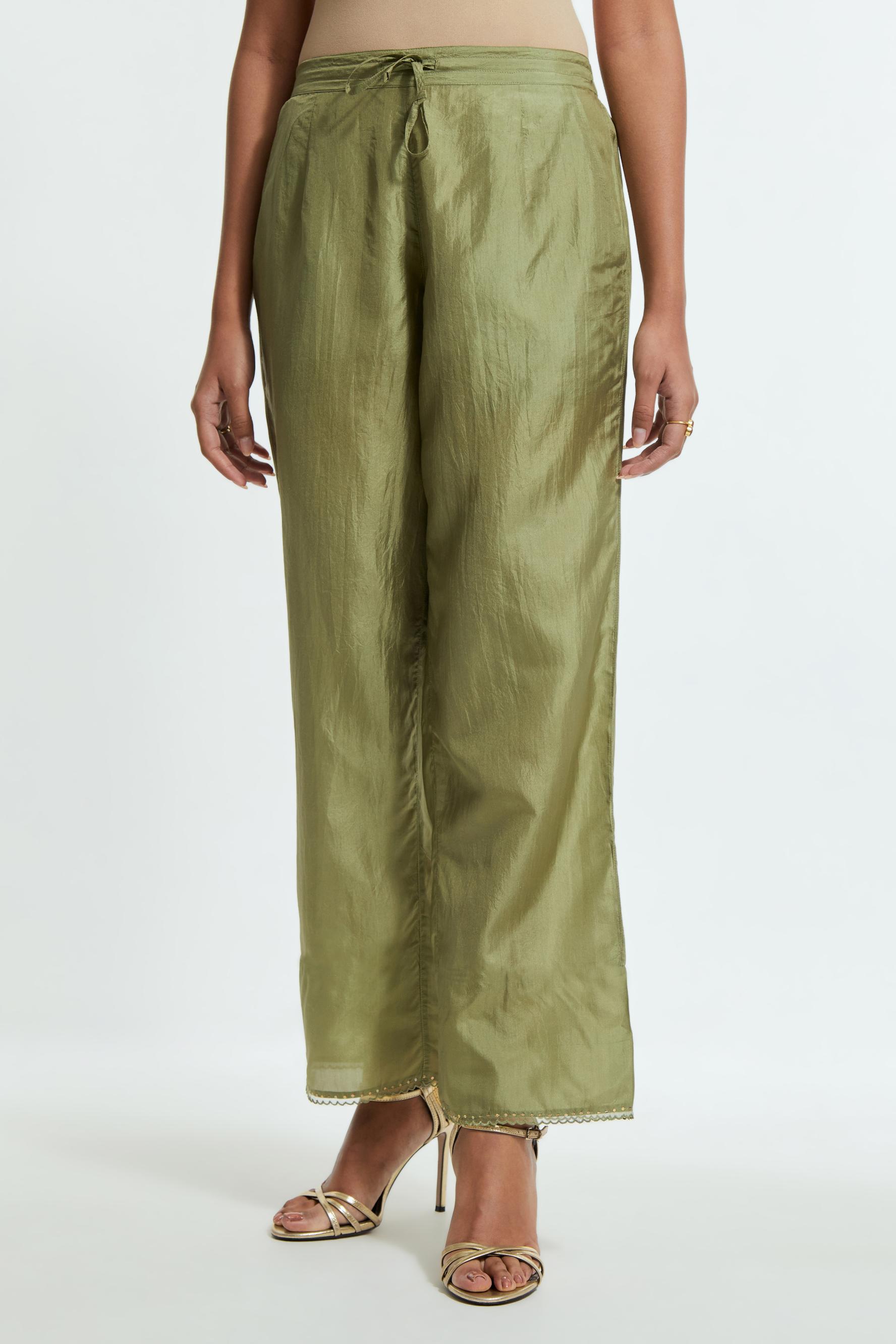 Green silk straight pants detailed with scalloped organza edging at the hem, delicately highlighted with gold sequins work.