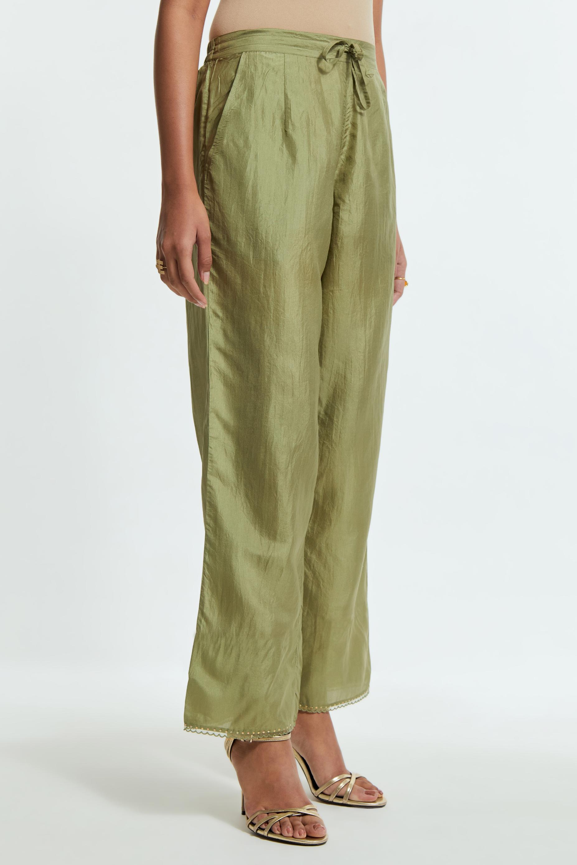 Green silk straight pants detailed with scalloped organza edging at the hem, delicately highlighted with gold sequins work.