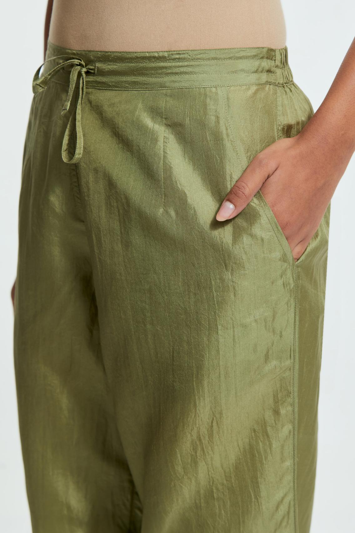Green silk straight pants detailed with scalloped organza edging at the hem, delicately highlighted with gold sequins work.