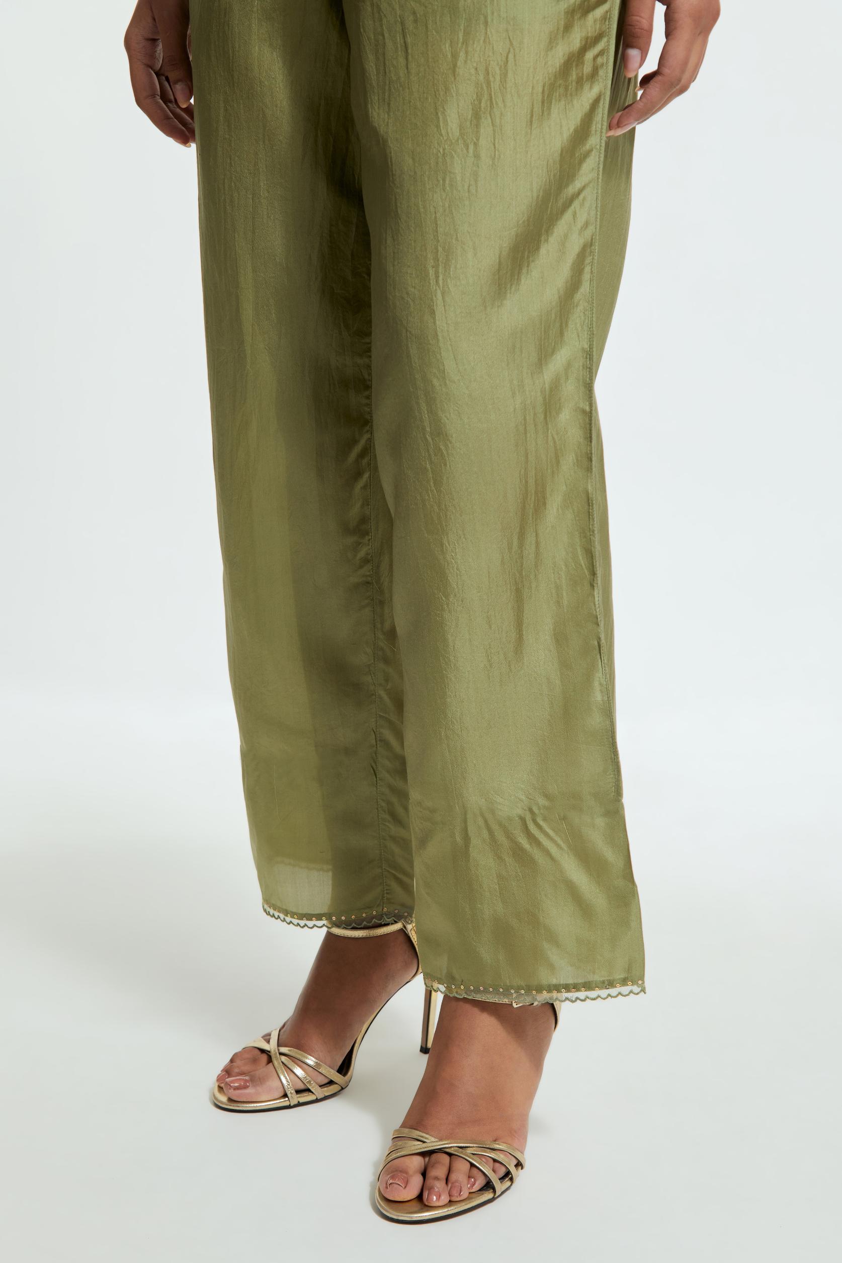Green silk straight pants detailed with scalloped organza edging at the hem, delicately highlighted with gold sequins work.