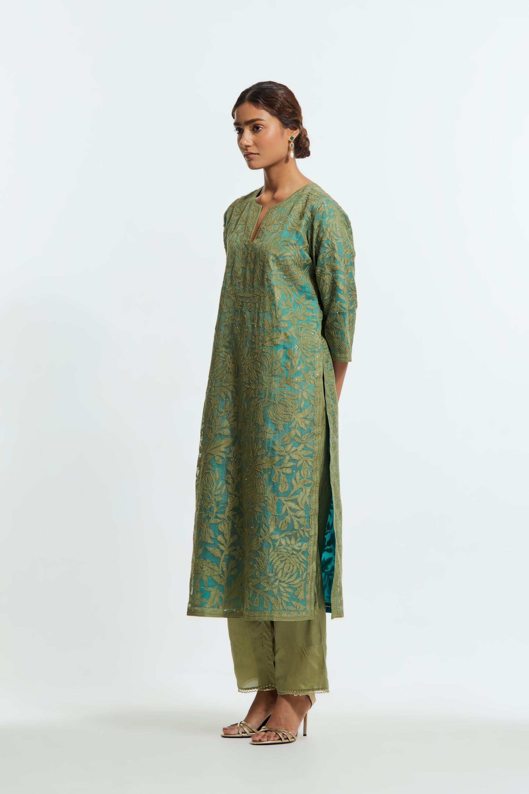 Green silk organza straight kurta set featuring an all-over silk appliqué trellis jaal, delicately highlighted with subtle sequins.