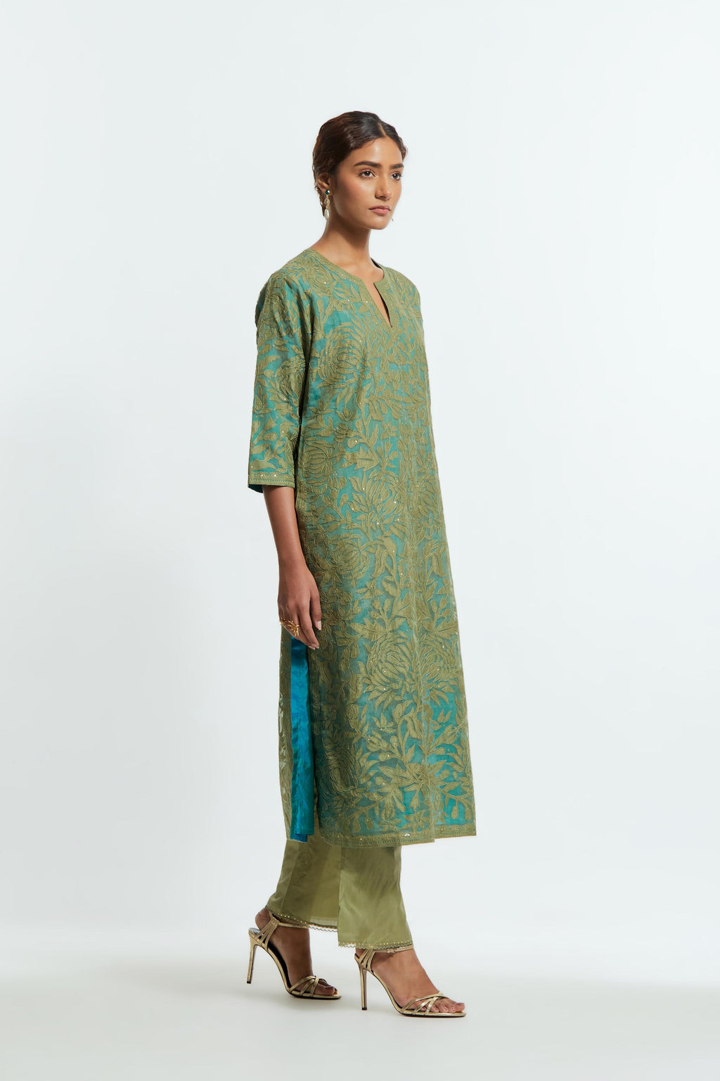 Green silk organza straight kurta set featuring an all-over silk appliqué trellis jaal, delicately highlighted with subtle sequins.