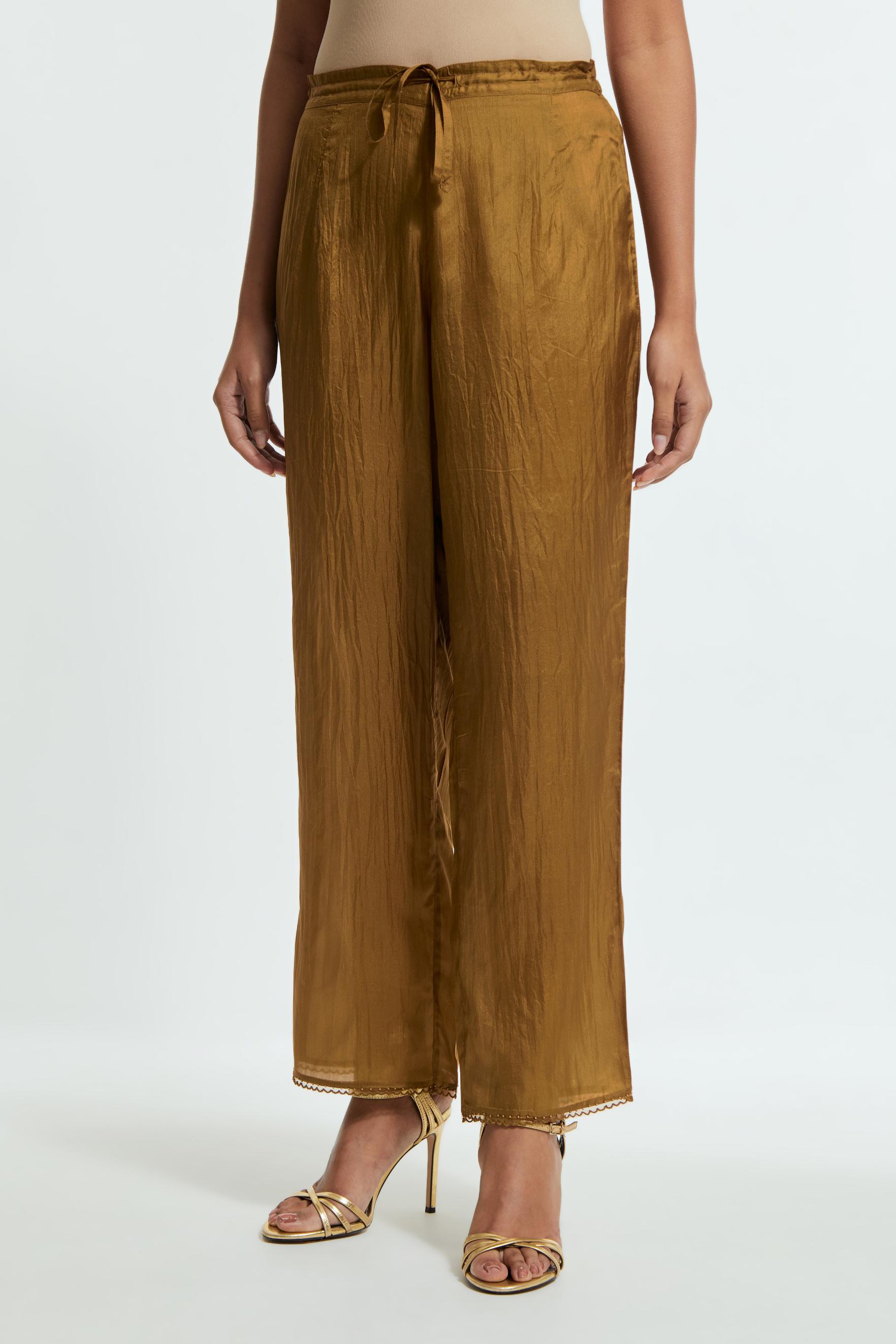Olive silk straight pants detailed with scalloped organza edging at the hem, delicately highlighted with tonal beadwork.