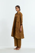 Olive silk organza A-line short kurta featuring appliqué bird motifs gracefully placed across the front, back and sleeves. Paired with Olive silk straight pants detailed with scalloped organza edging at the hem, delicately highlighted with tonal beadwork.