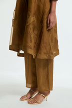 Olive silk organza A-line short kurta featuring appliqué bird motifs gracefully placed across the front, back and sleeves. Paired with Olive silk straight pants detailed with scalloped organza edging at the hem, delicately highlighted with tonal beadwork.