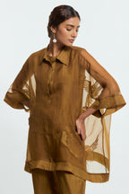 Olive silk organza short kaftan top with a sheer finish, delicately adorned with appliqué bird motifs along the hem and sides. Paired with olive silk straight pants detailed with scalloped organza edging at hem, delicately highlighted with tonal beadwork.