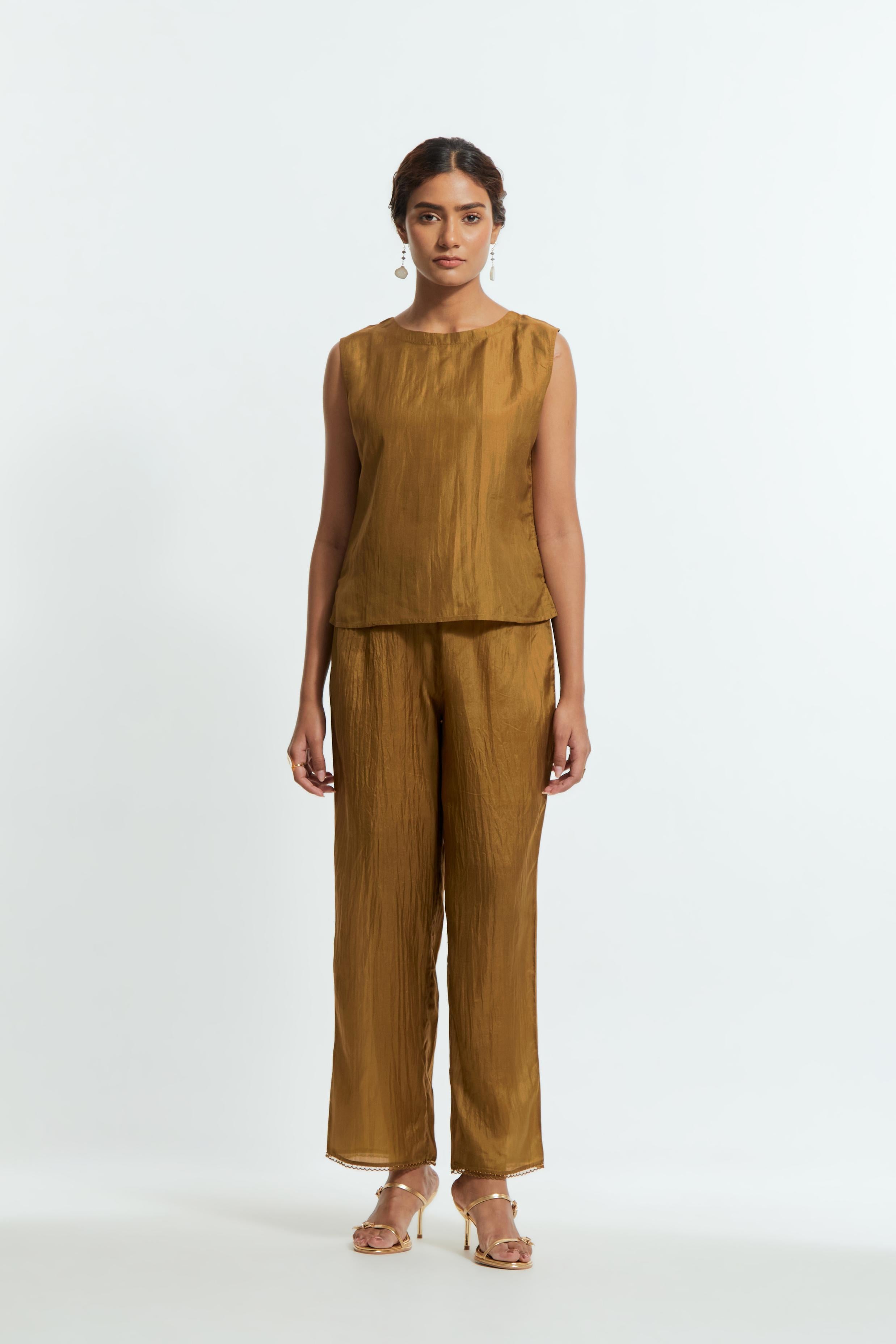 Olive silk organza short kaftan top with a sheer finish, delicately adorned with appliqué bird motifs along the hem and sides. Paired with olive silk straight pants detailed with scalloped organza edging at hem, delicately highlighted with tonal beadwork.