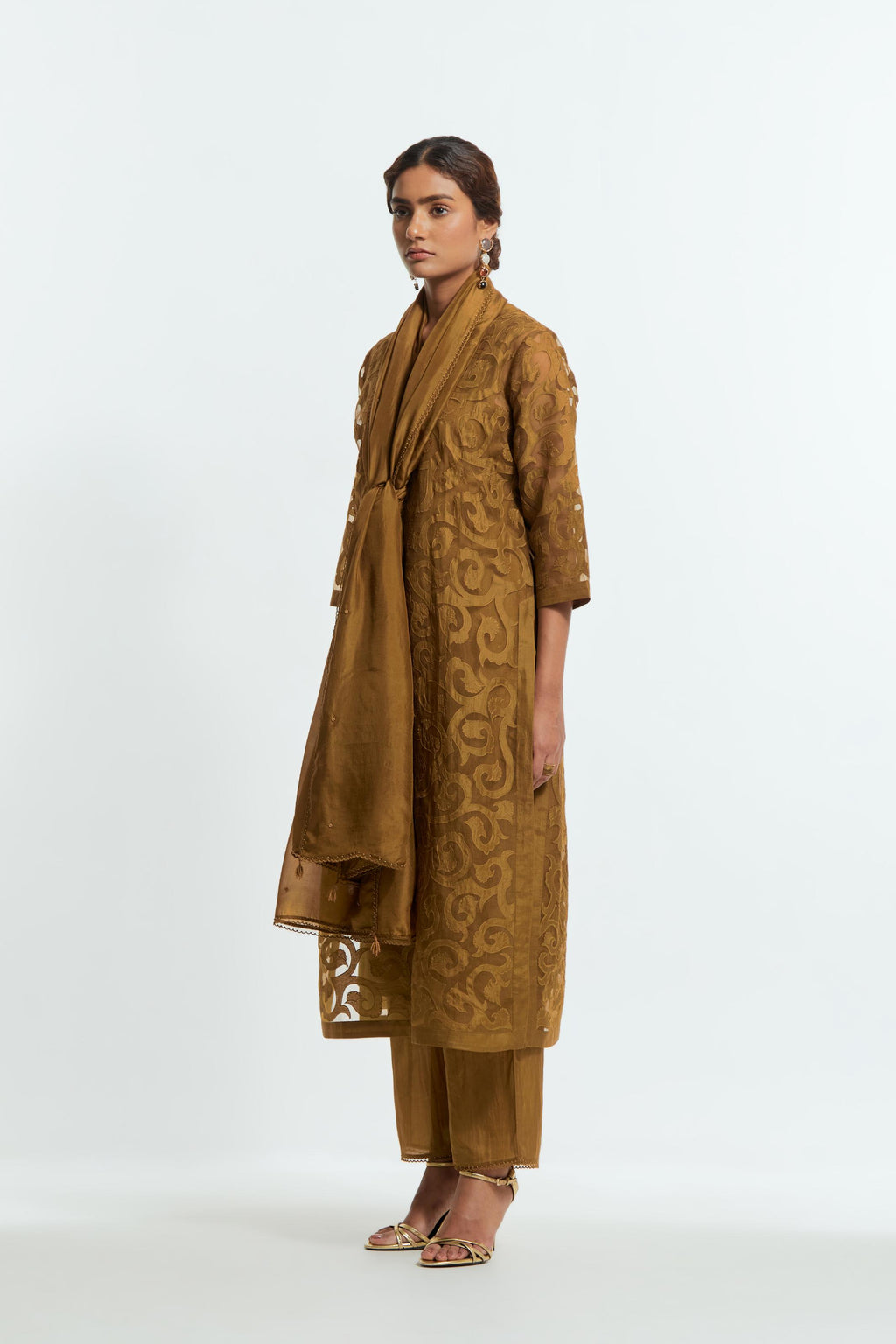 Olive silk organza straight kurta set featuring an all-over silk appliqué trellis jaal, delicately highlighted with aari thread work.