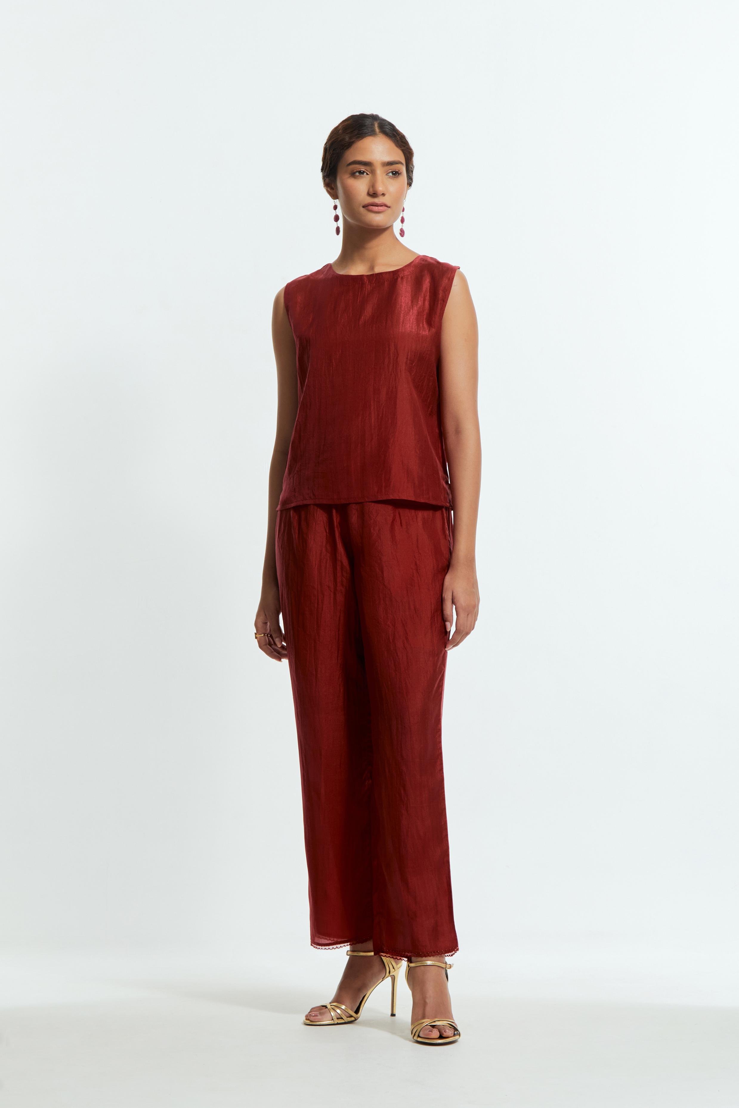 Red silk organza short kaftan top with a sheer finish, delicately adorned with appliqué bird motifs along the hem and sides. Paired with Red silk straight pants detailed with scalloped organza edging at the hem, delicately highlighted with tonal beadwork.