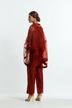 Red silk organza short kaftan top with a sheer finish, delicately adorned with appliqué bird motifs along the hem and sides. Paired with Red silk straight pants detailed with scalloped organza edging at the hem, delicately highlighted with tonal beadwork.