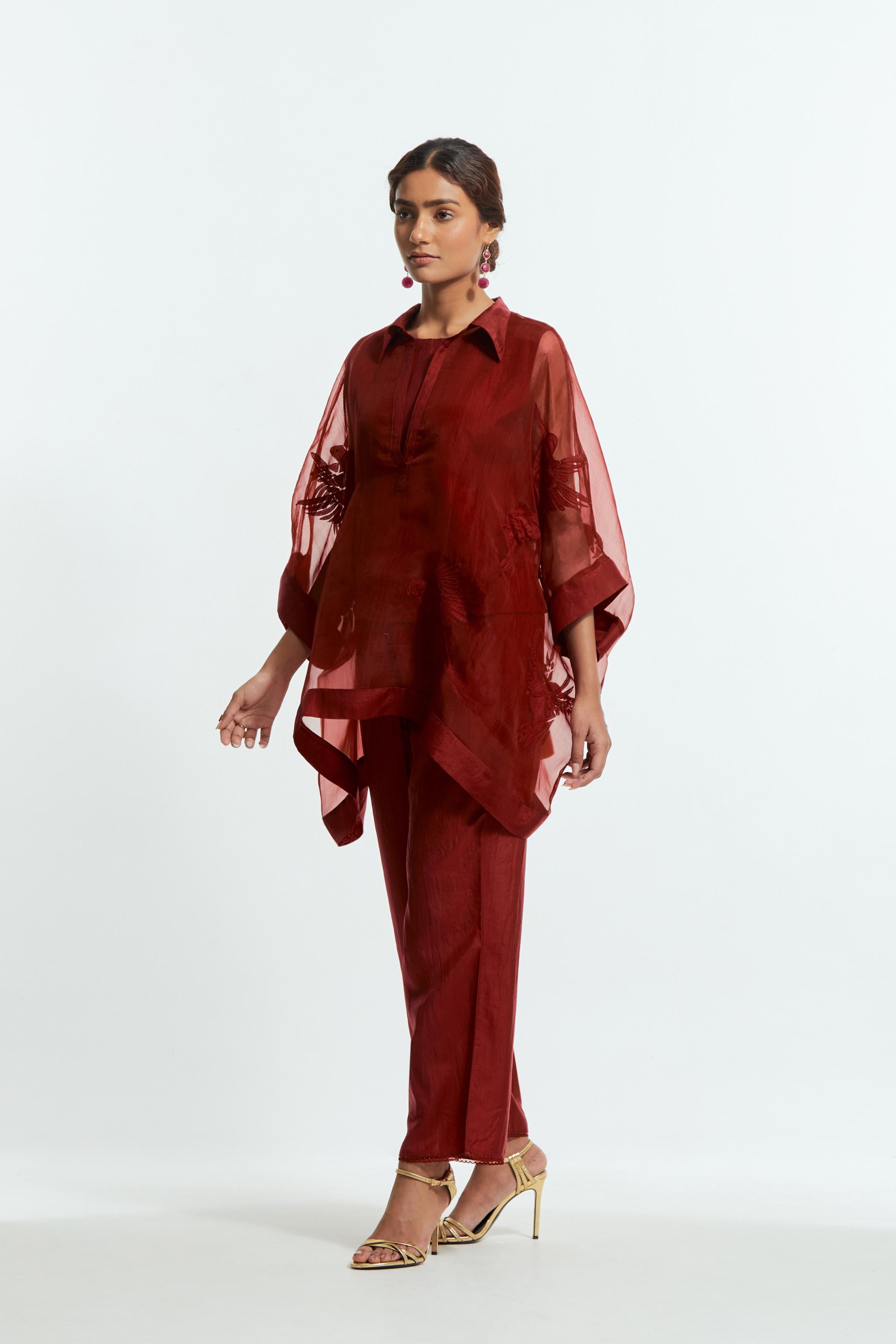 Red silk organza short kaftan top with a sheer finish, delicately adorned with appliqué bird motifs along the hem and sides. Paired with Red silk straight pants detailed with scalloped organza edging at the hem, delicately highlighted with tonal beadwork.