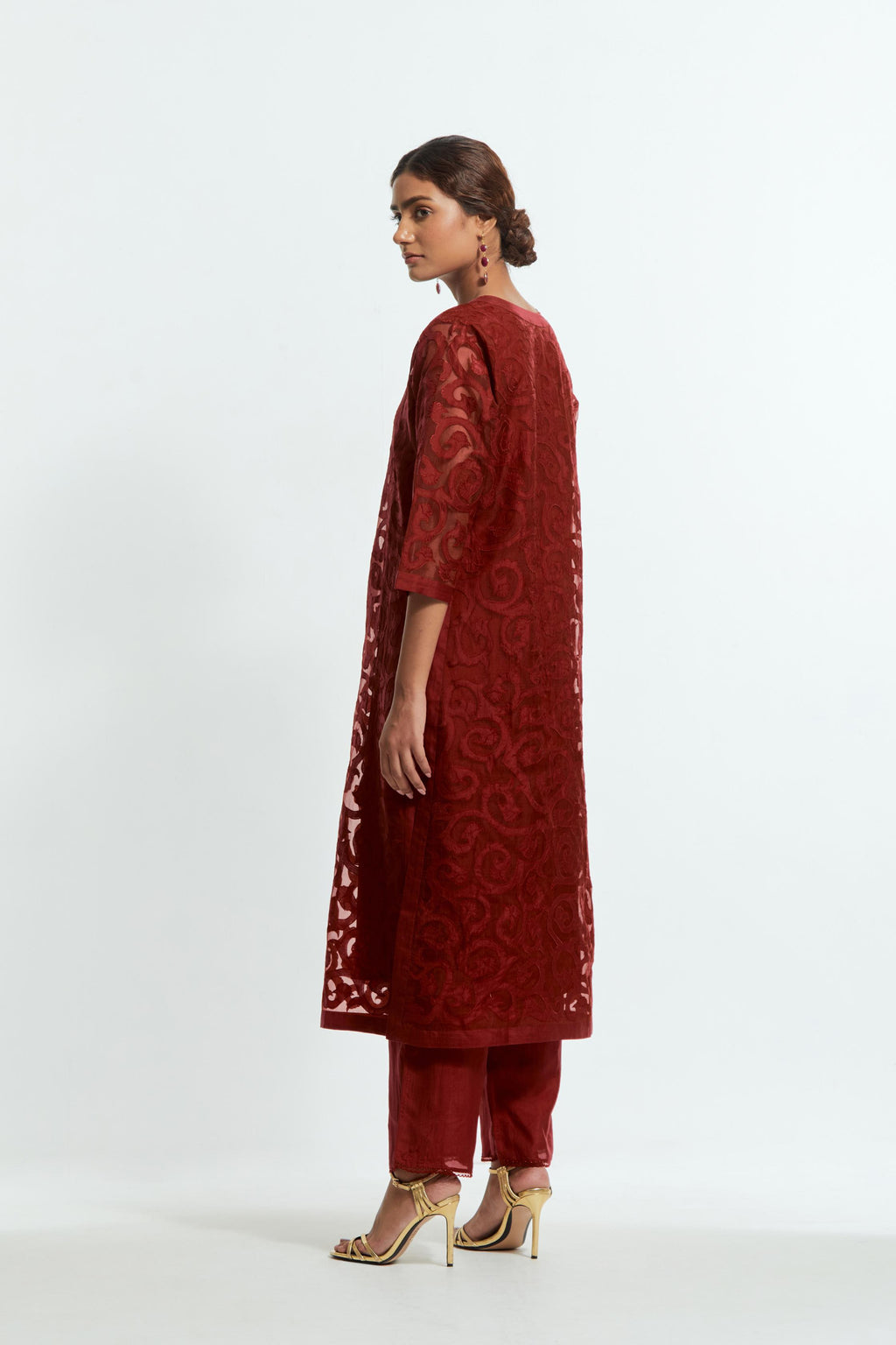 Red silk organza straight kurta set featuring an all-over silk appliqué trellis jaal, delicately highlighted with aari threadwork.