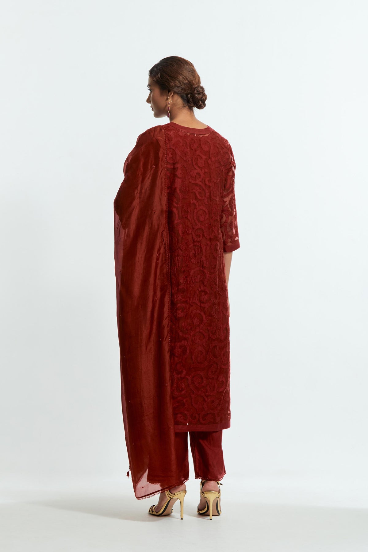 Red silk organza straight kurta set featuring an all-over silk appliqué trellis jaal, delicately highlighted with aari threadwork.
