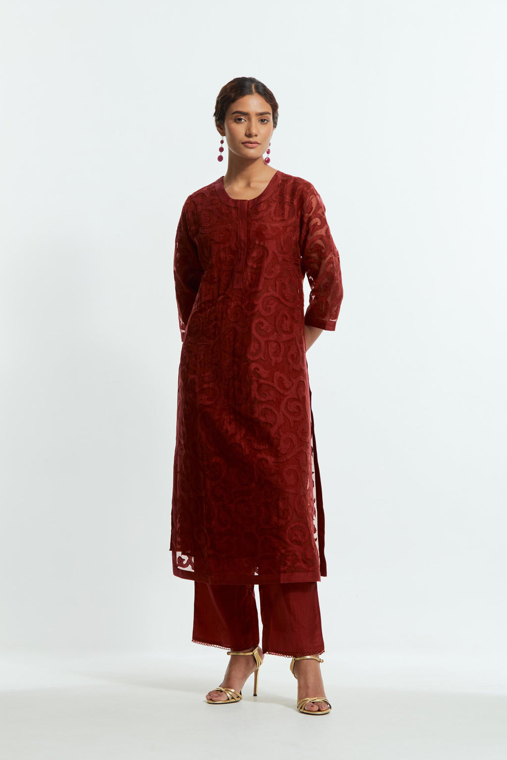Red silk organza straight kurta set featuring an all-over silk appliqué trellis jaal, delicately highlighted with aari threadwork.