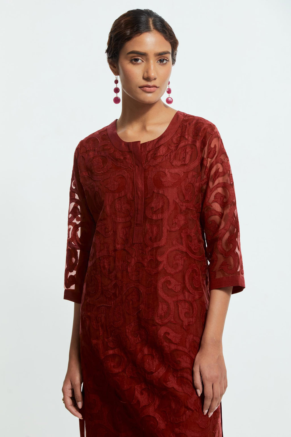 Red silk organza straight kurta set featuring an all-over silk appliqué trellis jaal, delicately highlighted with aari threadwork.