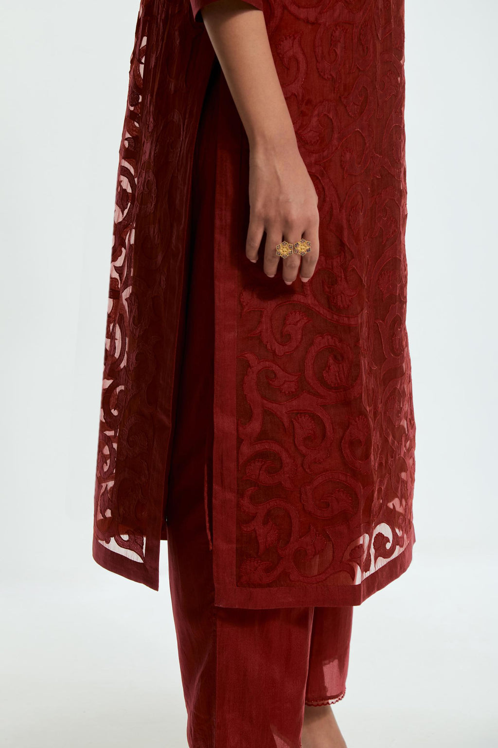 Red silk organza straight kurta set featuring an all-over silk appliqué trellis jaal, delicately highlighted with aari threadwork.