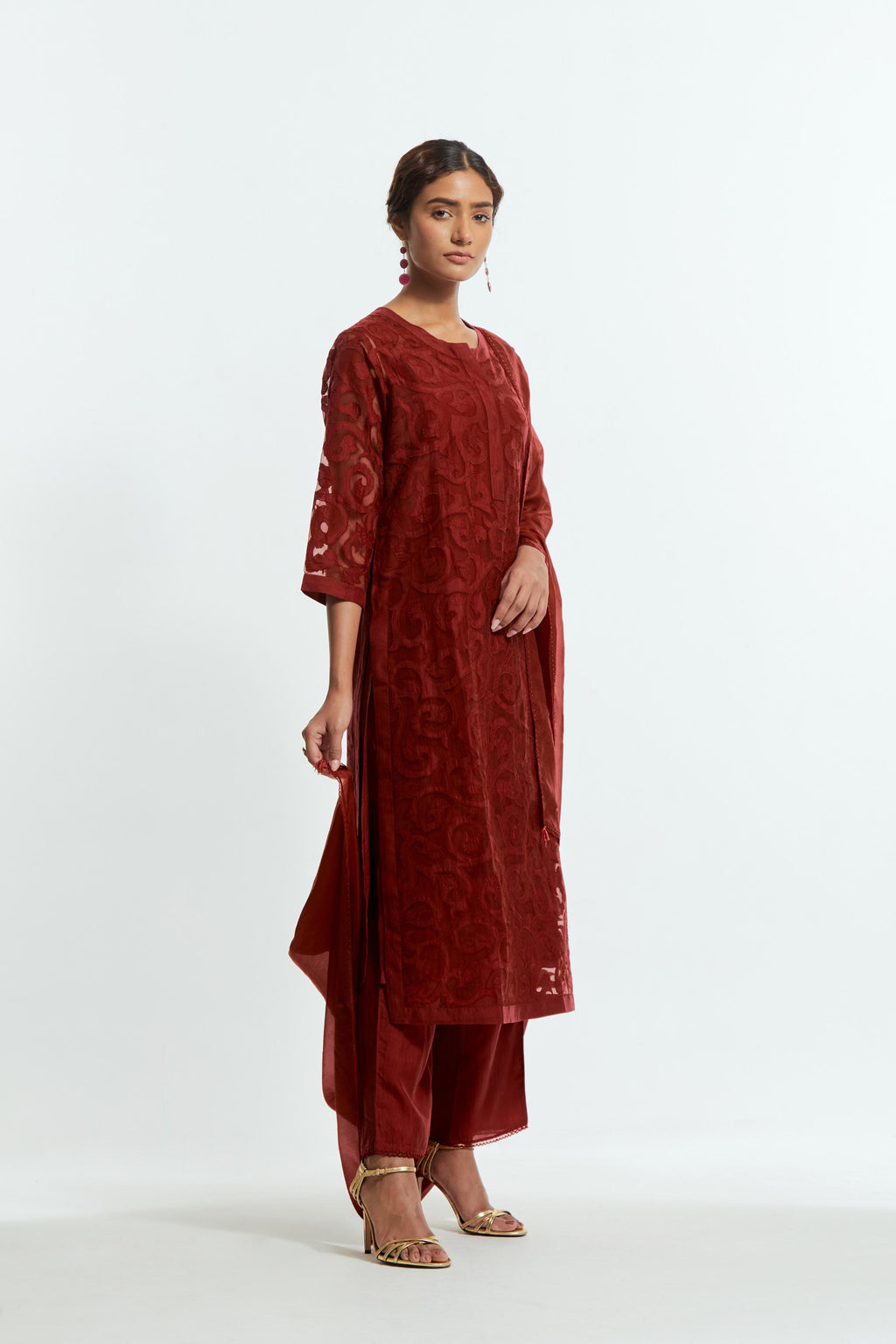 Red silk organza straight kurta set featuring an all-over silk appliqué trellis jaal, delicately highlighted with aari threadwork.