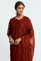 Red silk organza straight kurta set featuring an all-over silk appliqué trellis jaal, delicately highlighted with aari threadwork.