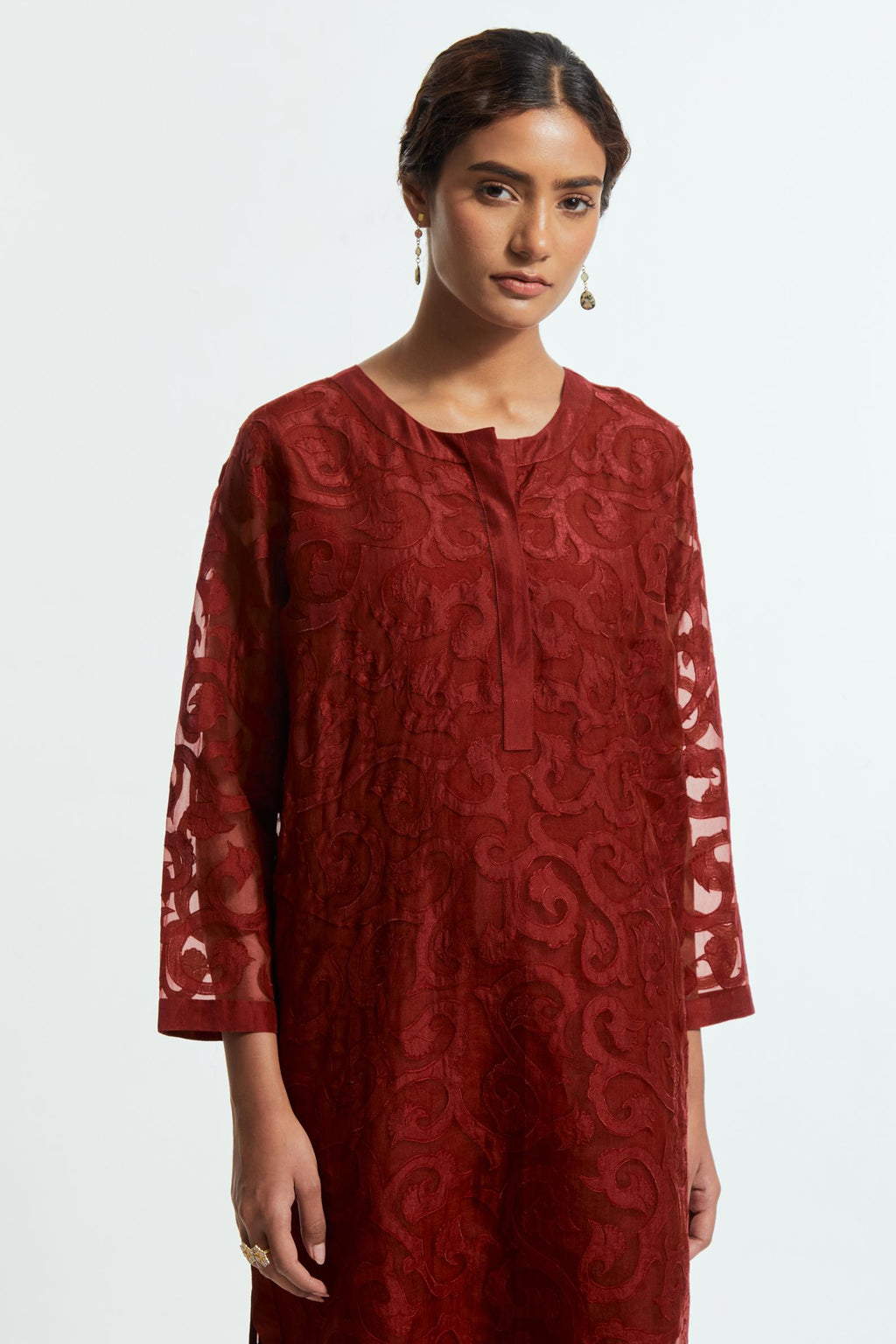 Red silk organza easy-fit short kurta set adorned with an all-over silk appliqué trellis jaal, delicately highlighted with aari thread embroidery.