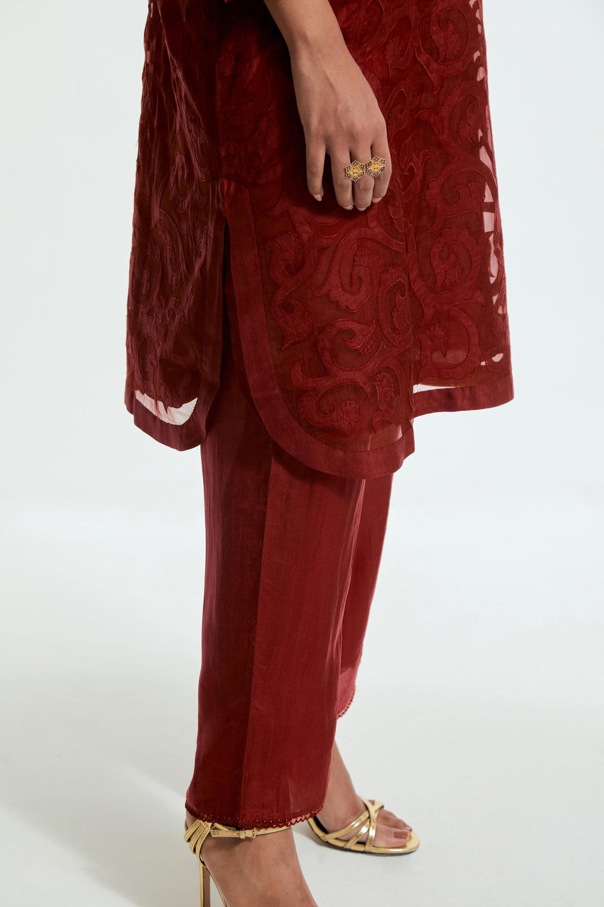 Red silk organza easy-fit short kurta set adorned with an all-over silk appliqué trellis jaal, delicately highlighted with aari thread embroidery.