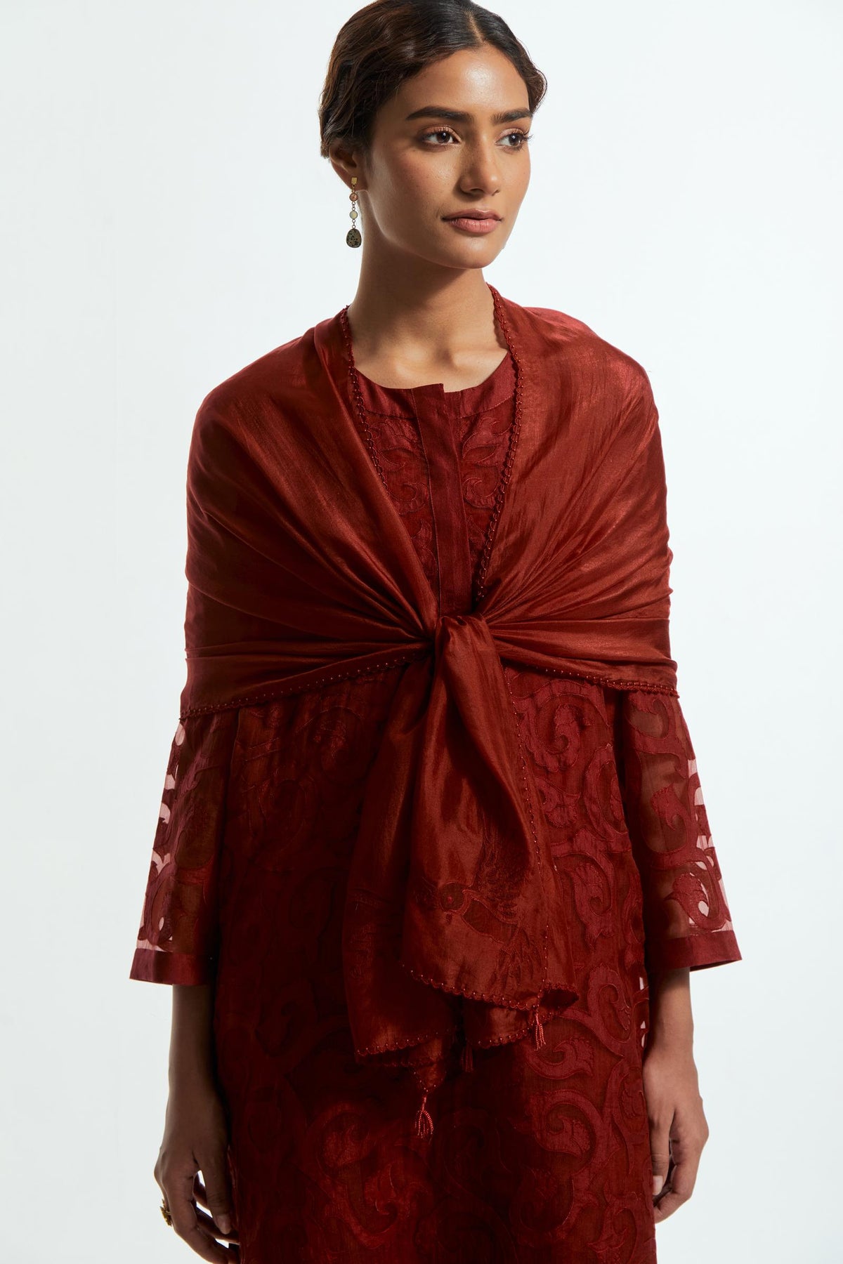Red silk organza easy-fit short kurta set adorned with an all-over silk appliqué trellis jaal, delicately highlighted with aari thread embroidery.
