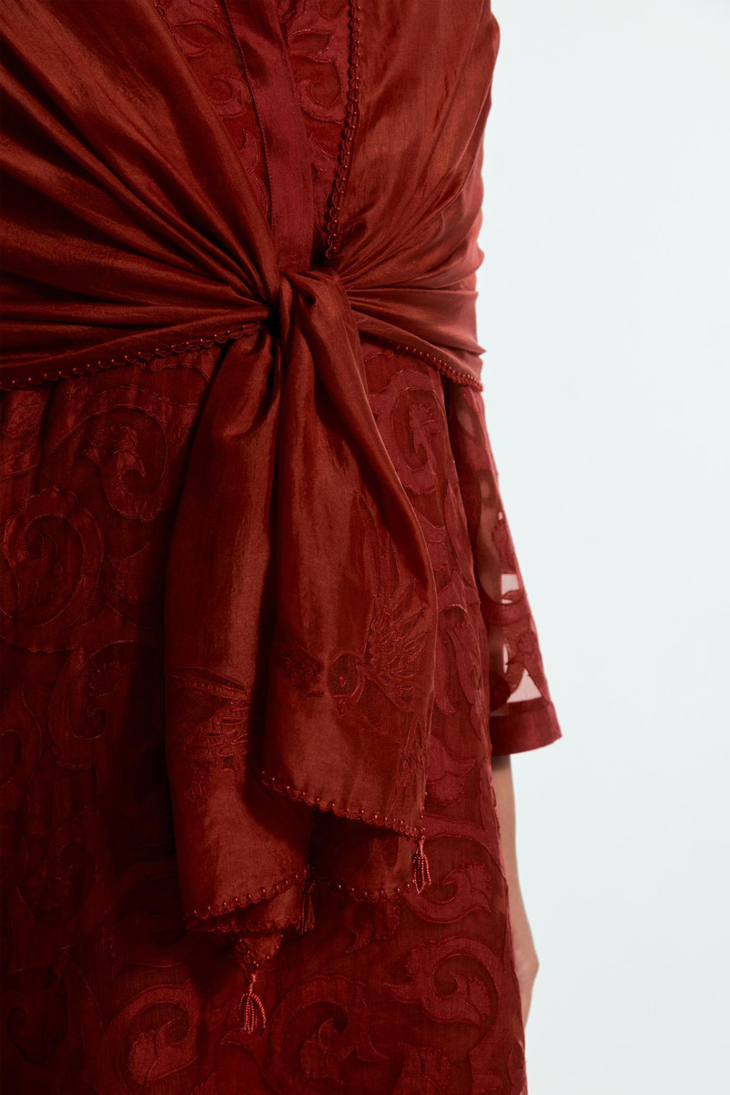Red light silk stole featuring bird motif appliqué embroidery at all four corners.