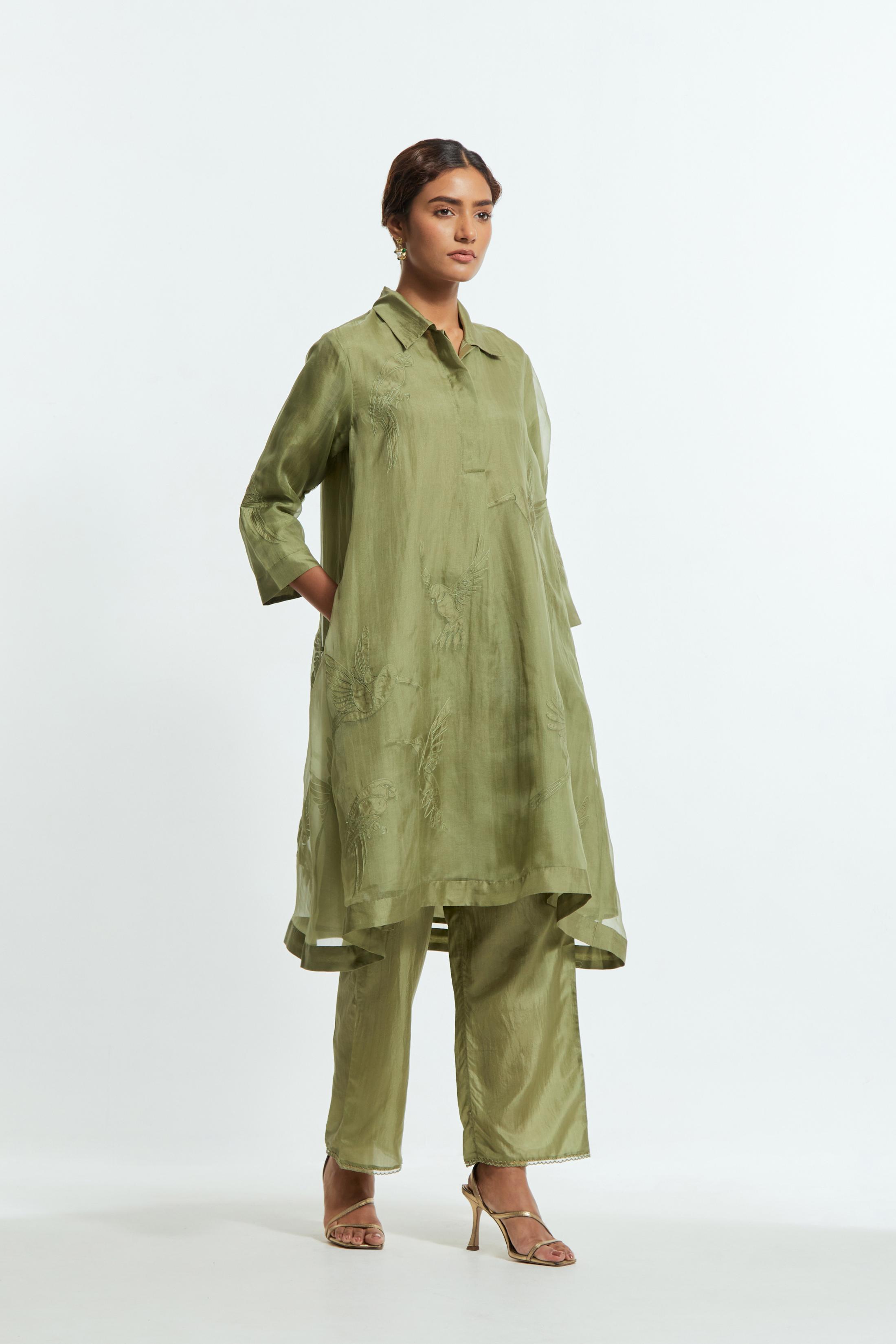 Green silk organza A-line short kurta featuring appliqué bird motifs gracefully placed across the front, back and sleeves. Paired with Green silk straight pants detailed with scalloped organza edging at the hem, delicately highlighted with tonal beadwork.