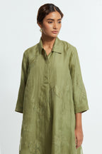 Green silk organza A-line short kurta featuring appliqué bird motifs gracefully placed across the front, back and sleeves. Paired with Green silk straight pants detailed with scalloped organza edging at the hem, delicately highlighted with tonal beadwork.