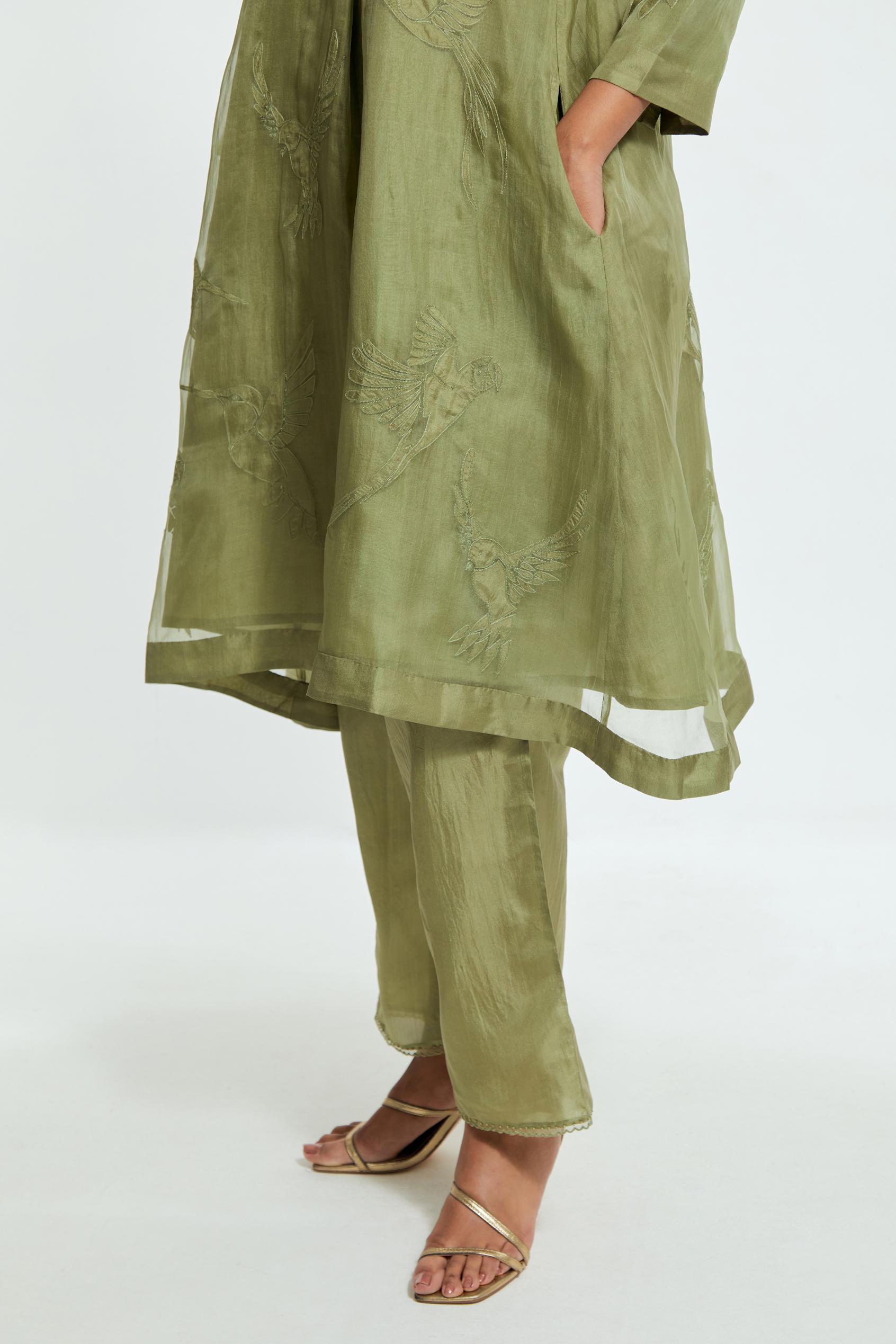 Green silk organza A-line short kurta featuring appliqué bird motifs gracefully placed across the front, back and sleeves. Paired with Green silk straight pants detailed with scalloped organza edging at the hem, delicately highlighted with tonal beadwork.