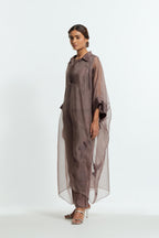 Grey silk organza kaftan with a sheer finish, delicately adorned with appliqué bird motifs along the hem and sides. Paired with Grey silk straight pants detailed with scalloped organza edging at the hem, delicately highlighted with tonal beadwork.