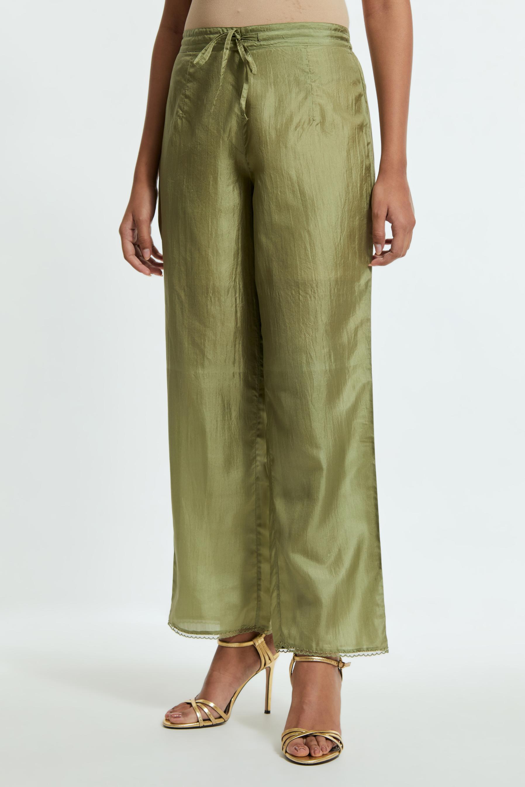 Green silk straight pants detailed with scalloped organza edging at the hem, delicately highlighted with tonal beadwork.
