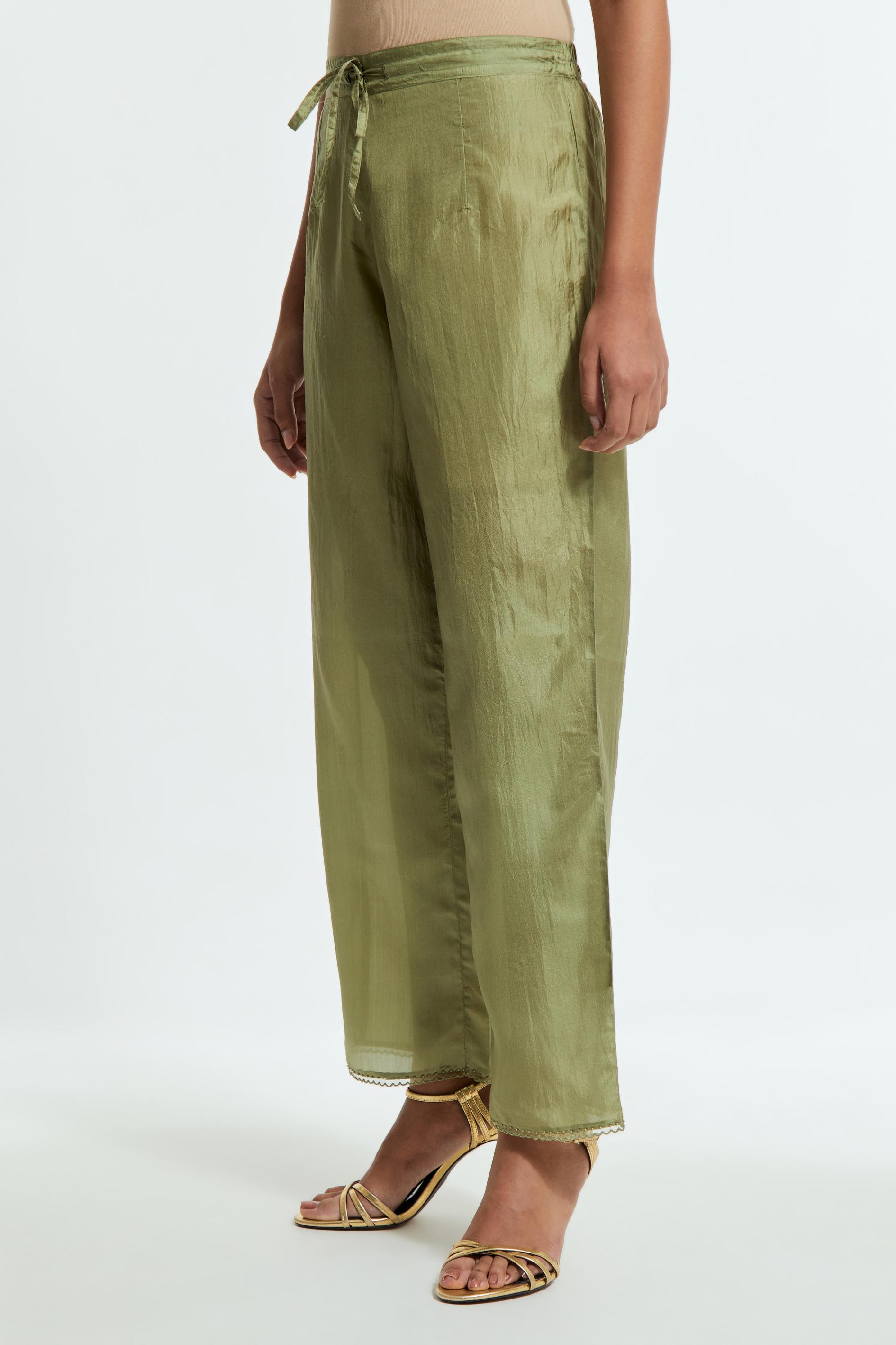 Green silk straight pants detailed with scalloped organza edging at the hem, delicately highlighted with tonal beadwork.