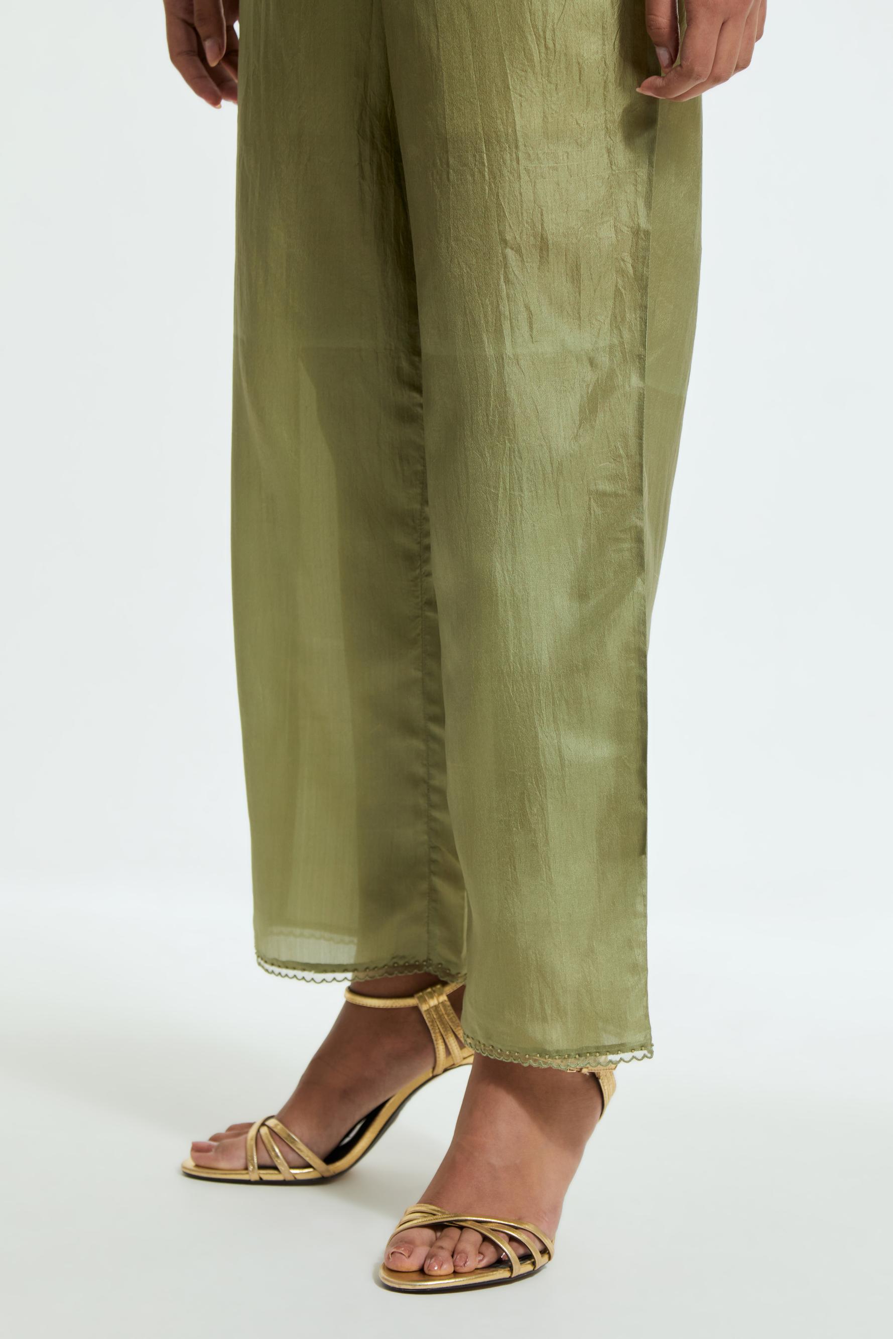Green silk straight pants detailed with scalloped organza edging at the hem, delicately highlighted with tonal beadwork.
