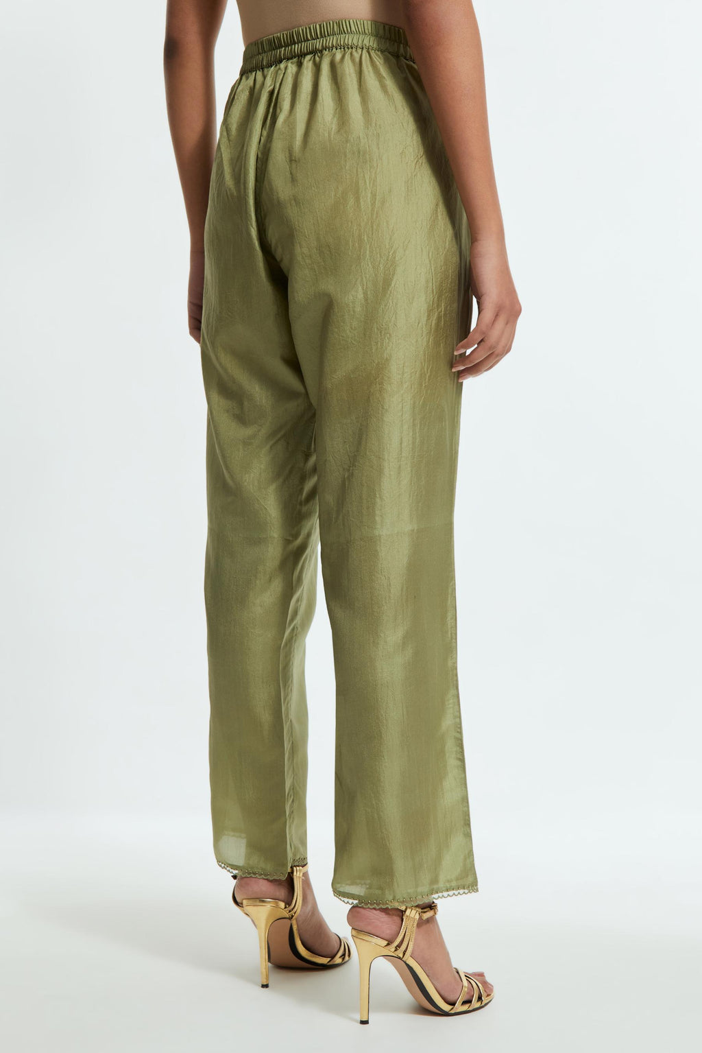Green silk straight pants detailed with scalloped organza edging at the hem, delicately highlighted with tonal beadwork.