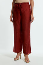 Red silk straight pants detailed with scalloped organza edging at the hem, delicately highlighted with tonal beadwork.