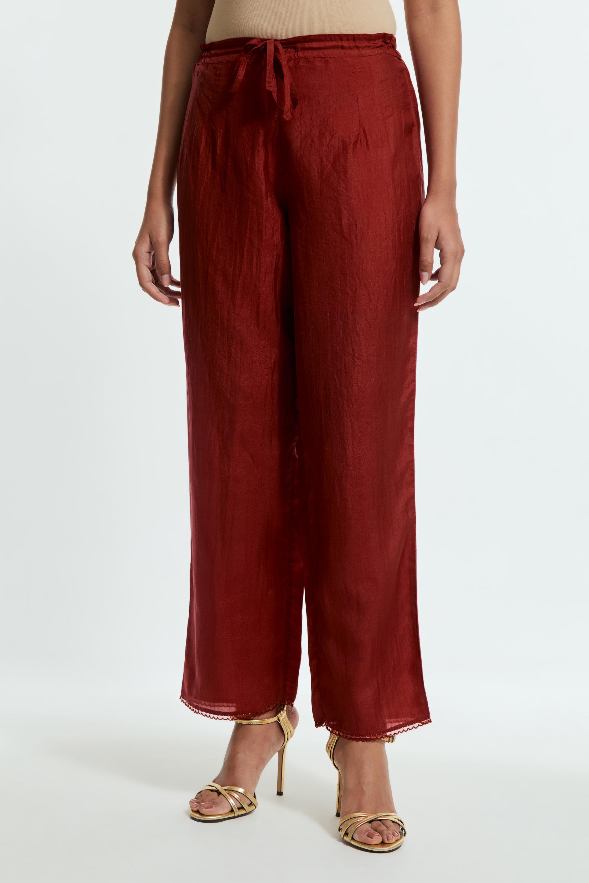 Red silk straight pants detailed with scalloped organza edging at the hem, delicately highlighted with tonal beadwork.
