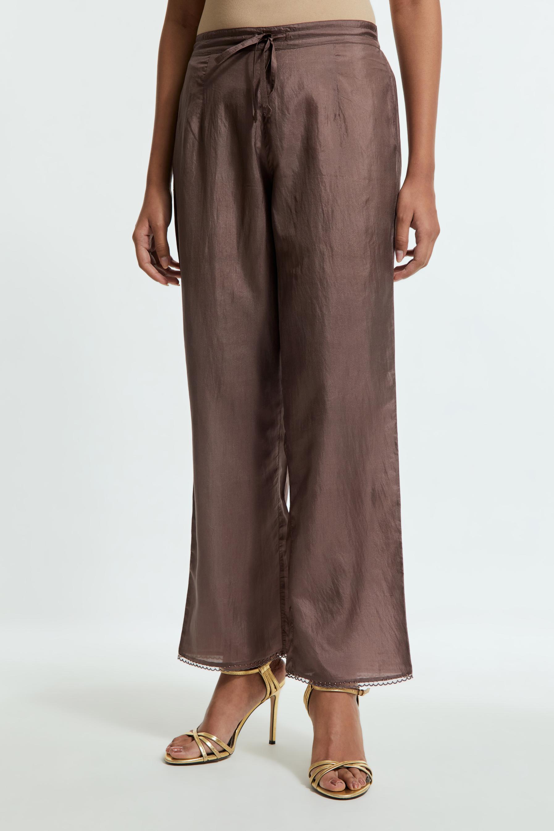 Grey silk straight pants detailed with scalloped organza edging at the hem, delicately highlighted with tonal beadwork.