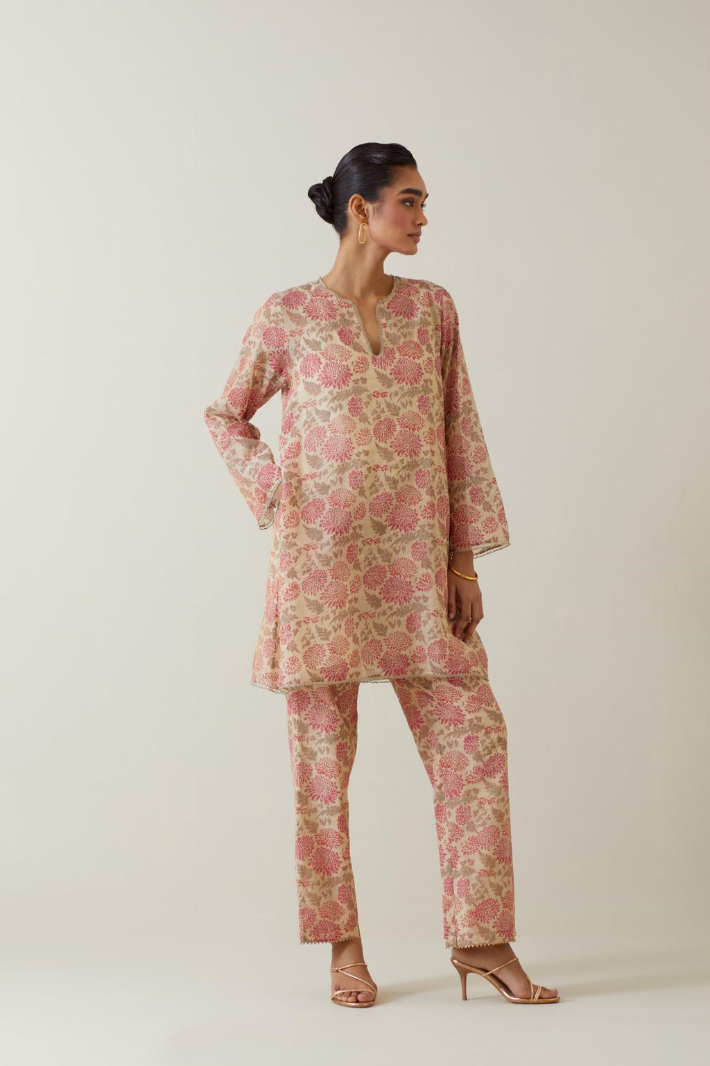 Beige tissue chanderi hand block printed easy fit short kurta, highlighted with scalloped organza at edges, paired with beige tissue chanderi all-over floral hand block printed straight pants.