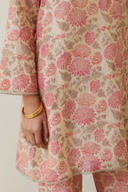Beige tissue chanderi hand block printed easy fit short kurta, highlighted with scalloped organza at edges, paired with beige tissue chanderi all-over floral hand block printed straight pants.