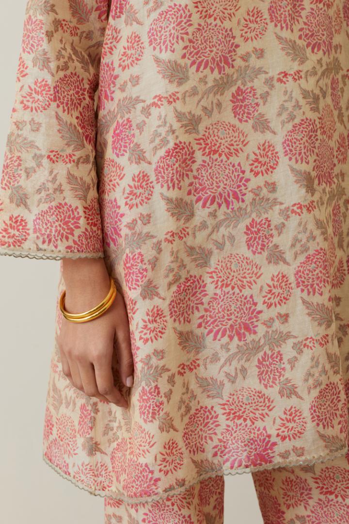 Beige tissue chanderi hand block printed easy fit short kurta, highlighted with scalloped organza at edges, paired with beige tissue chanderi all-over floral hand block printed straight pants.