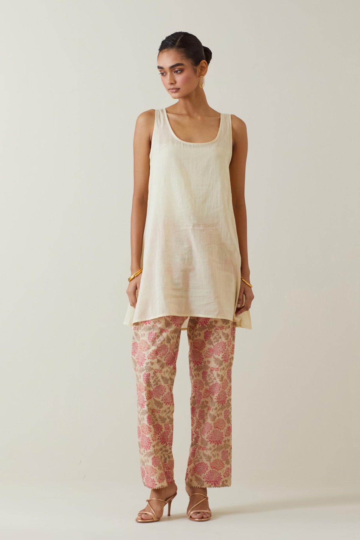 Beige tissue chanderi hand block printed easy fit short kurta, highlighted with scalloped organza at edges, paired with beige tissue chanderi all-over floral hand block printed straight pants.